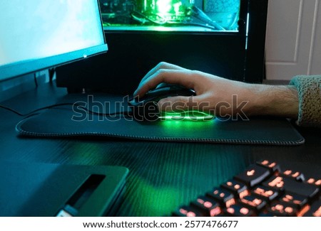 Computer mouse in operation, bright backlight, e-sports concept