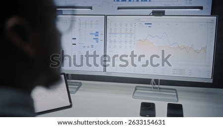 Computer with Multi-Monitor Desktop System with Online Trading Software. Stock Exchange Trader Analyzing Real-Time Stocks, Exchange Market Charts. African American Investment Agent Working in Office.