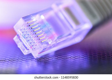 Computer network cable. The local wire lies on the ribbed surface highlighted in blue-pink red. Technological background. Macro