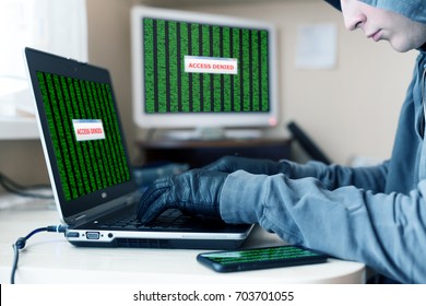 Computer Network Professional working on Laptop trying to hack the Account password using Gloves to avoid leaving fingertips