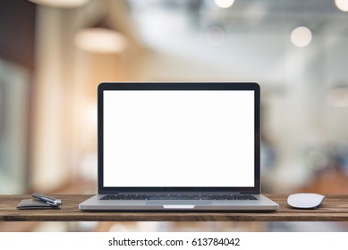 Computer notebook and mouse with a coffee shop behind the scenes Blur coffee shop, Blur restaurant sun flare effect photo. - Shutterstock ID 613784042