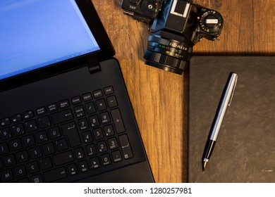 computer and notebook on table