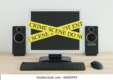 Computer On A Desk With A Crime Scene Label.