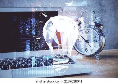 Computer on desktop in office with bulb icon hologram. Double exposure. Concept of idea. - Shutterstock ID 2189028041