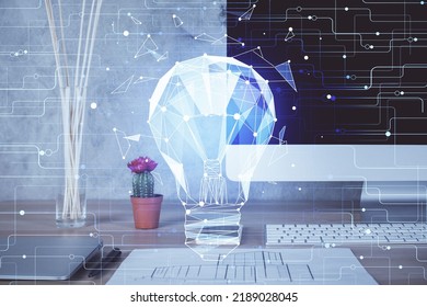 Computer on desktop in office with bulb icon hologram. Double exposure. Concept of idea. - Shutterstock ID 2189028045