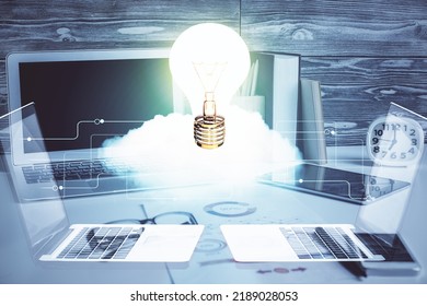 Computer on desktop in office with bulb icon hologram. Double exposure. Concept of idea. - Shutterstock ID 2189028053