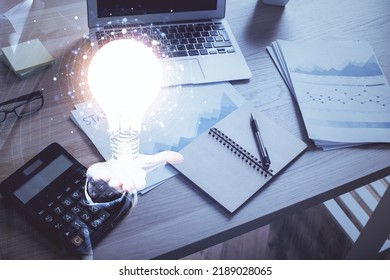 Computer on desktop in office with bulb icon hologram. Double exposure. Concept of idea. - Shutterstock ID 2189028065