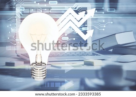 Computer on desktop in office with bulb icon hologram. Double exposure. Concept of idea.