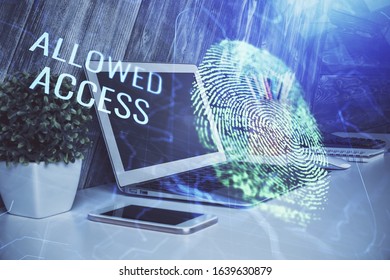 Computer on desktop in office with finger print drawing. Double exposure. Concept of business data security.
