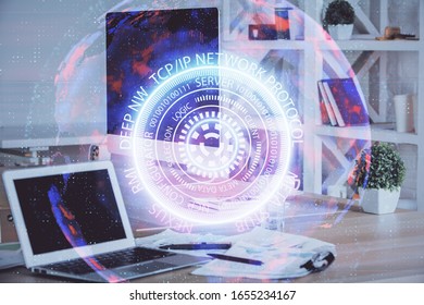 Computer on desktop in office with technology theme hologram. Multi exposure. Tech concept.