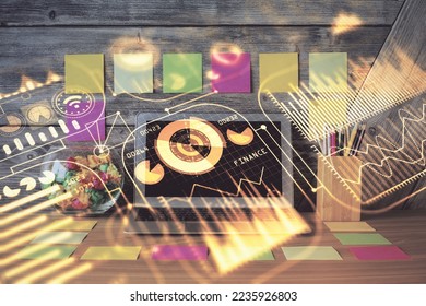 Computer on desktop in office with technology theme hologram. Double exposure. Tech concept.