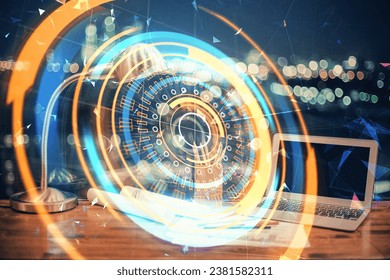 Computer on desktop in office with technology theme hologram. Multi exposure. Tech concept.