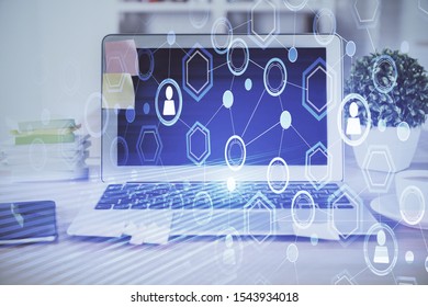 Computer on desktop with social network theme icon. Multi exposure. Concept of international connections. - Shutterstock ID 1543934018