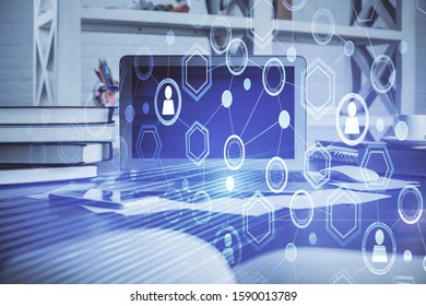 Computer on desktop with social network theme icon. Multi exposure. Concept of international connections. - Shutterstock ID 1590013789
