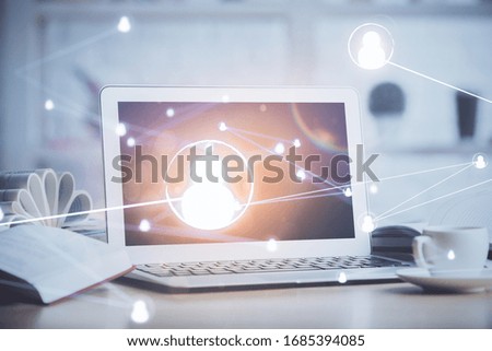 Computer on desktop with social network hologram. Multi exposure. Concept of international people connections.