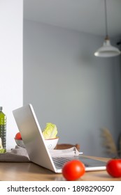 Computer On The Kitchen Table Prepared To Watch Virtual Cooking Class