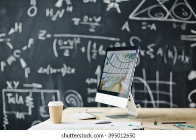 Computer on the table with blackboard in the background - Powered by Shutterstock