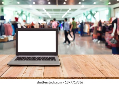 Computer on the table, blur image of inside the exhibition center building as background.