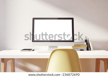 the computer is on the table in a bright interior
