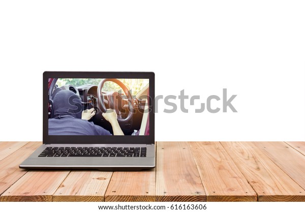 Computer on the table, image of thieves trying to\
open car door on\
screen.