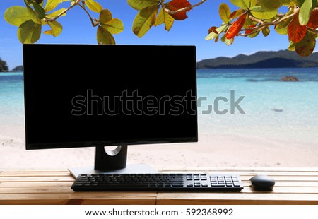 Computer on table sea view backdrop.copy space.