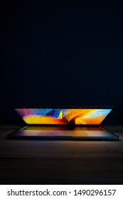 computer open in dark room 