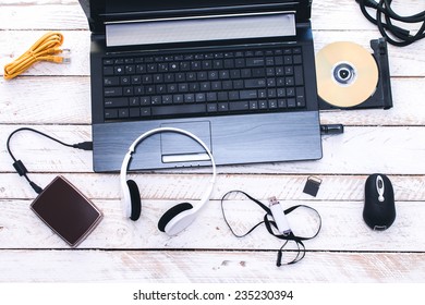 Computer Peripherals & Laptop Accessories. Composition On White Wooden Board.