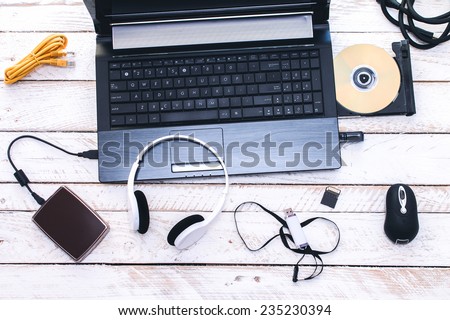Computer Peripherals & Laptop Accessories. Composition on white wooden board.