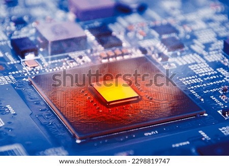 The computer processor CPU overheating and smokes around on computer motherboard, blue logic board with microprocessor.