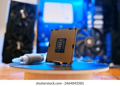 Computer processor with thermal paste close up. Modern computer part with PC case on background. Building personal gaming and workstation pc concept