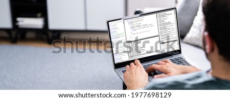 Computer Programmer Using Development Software On Laptop