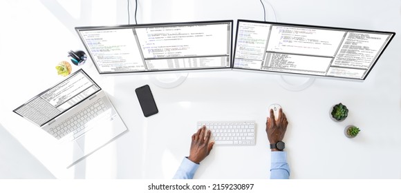 Computer Programmer Writing Program Code On Computer In Office 