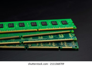 Computer Random Access Memory (RAM) chips on black wooden floor.                                       