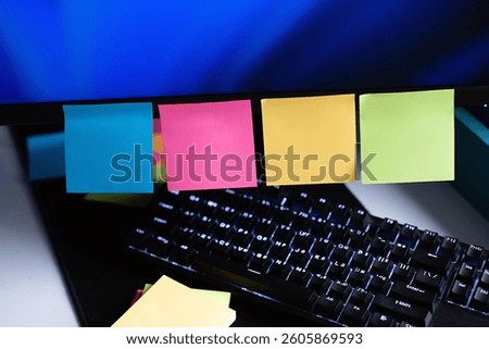 Computer in reminders with colored stickers notes on the display frame on table . Many unfulfilled tasks, deadline