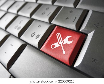 Computer repair service concept with work tools icons and symbol on a red laptop computer key for website and online business.