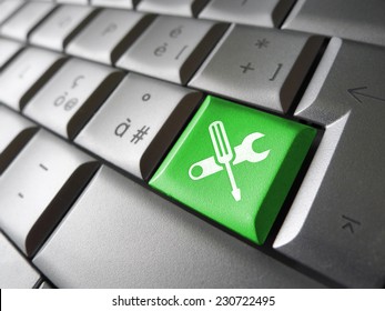 Computer repair service concept with work tools icons and symbol on a green laptop computer key for website and online business.
