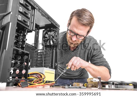 Computer repair. Computer technician working on a personal computer.