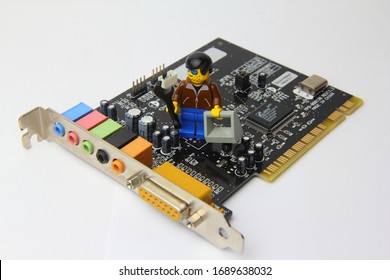 computer repair,  upgrade and support,  isolated video card with  lego man as engineer