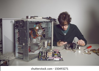 Computer Repair: Young Man Using Cellphone