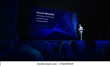 Computer Science Startup Conference: On Stage Speaker Does Presentation Of New Product, Talks About Neural Networks, Shows New AI, Big Data And Machine Learning App On Big Screen. Live Event