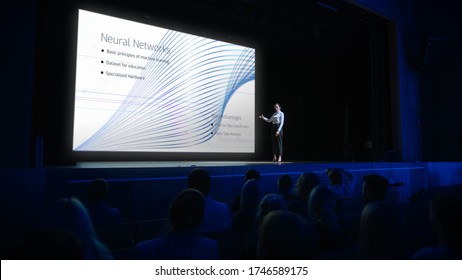 Computer Science Startup Conference: On Stage Speaker Does Presentation Of New Product, Talks About Neural Networks, Shows New AI, Big Data And Machine Learning App On Big Screen. Live Event