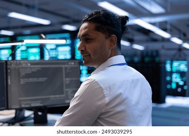 Computer scientist in data center using diagnostic tools and system monitoring software to identify root cause of errors. IT specialist in server farm establishment repairing equipment