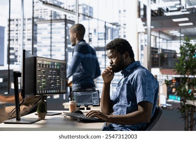 Computer scientist developing and maintaining machine learning APIs solving complex problems. African american man training predictive models capable of handling tasks such as language processing