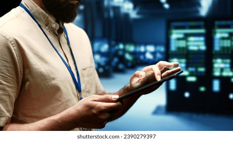 Computer scientist doing maintenance on VPN servers with high security standards used to adequately protect sensitive data. Data center providing secure internet connections for users