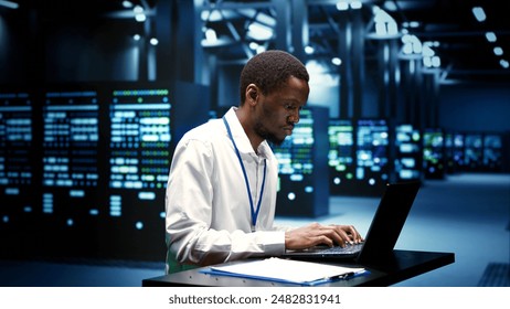 Computer scientist fixing server operational issues arising due to high CPU usage, insufficient memory and low disk space. African american expert monitoring performance trends