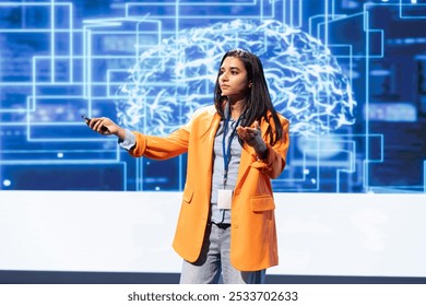Computer scientist presenting how AI technologies can bring businesses increased productivity during IT expo. Specialist talks about implementation of AI driven solutions during tech workshop