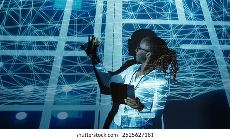 Computer scientist programming in AI server farm housing advanced equipment used for machine learning training. Developer running code on tablet to upgrade artificial intelligence rigs