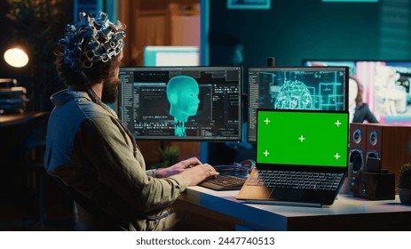 Computer scientist uploading brain into cyberspace, gaining digital persona using green screen laptop. Neuroscientist merging mind with AI, uploading consciousness into chroma key device, camera A