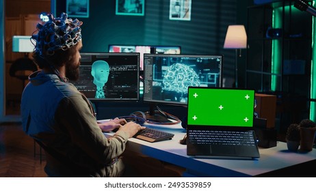 Computer scientist uploading brain into cyberspace, gaining digital persona using green screen laptop. Neuroscientist merging mind with AI, uploading consciousness into chroma key device, camera B - Powered by Shutterstock