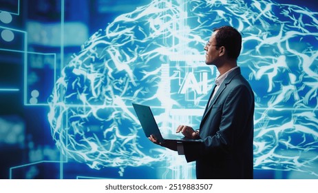 Computer scientist using laptop to implement artificial intelligence parallel processing, breaking up complex computational tasks enabling AI systems to process more input data faster, camera B